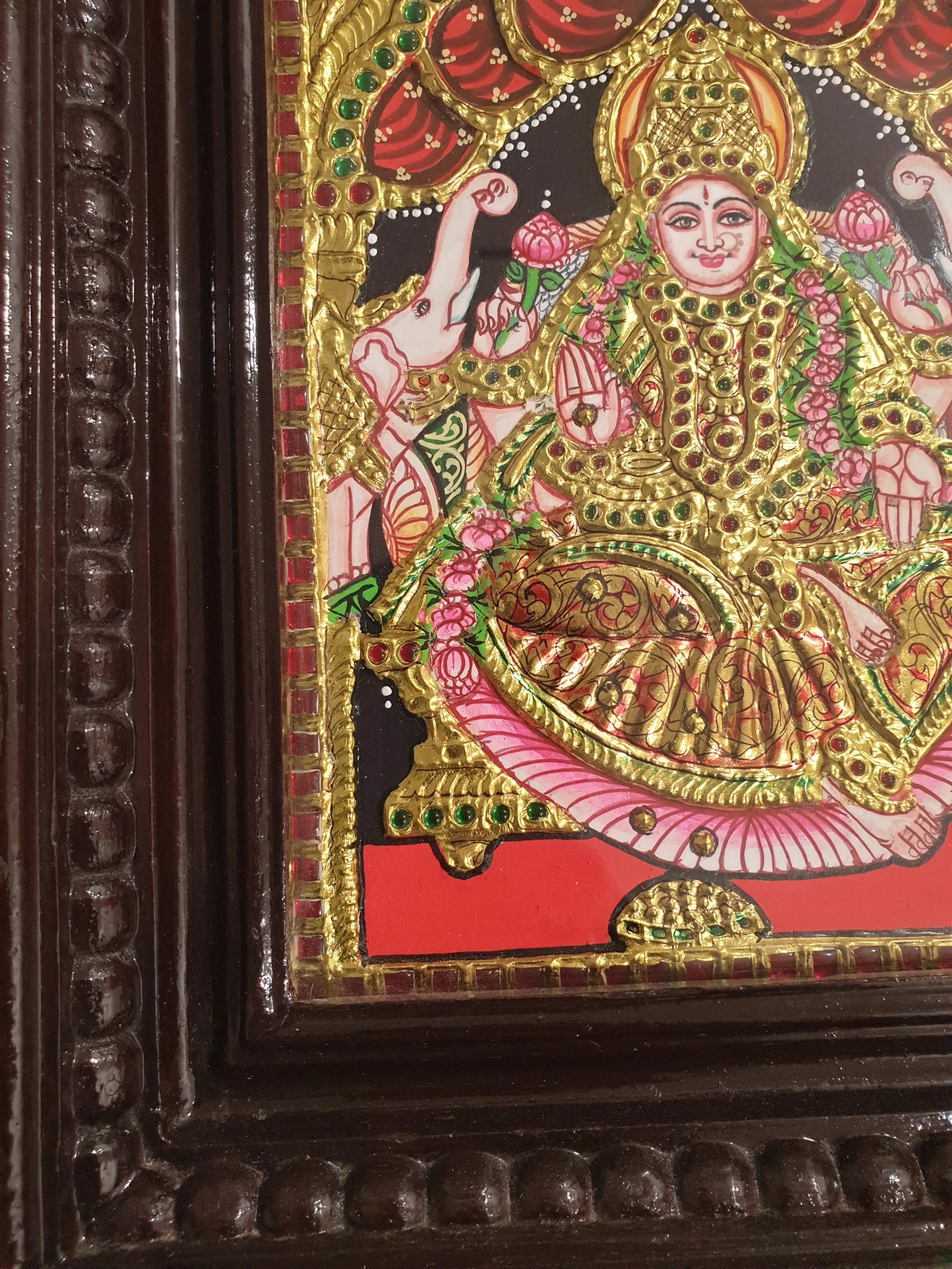 Decorative artwork with intricate designs and a gold frame.