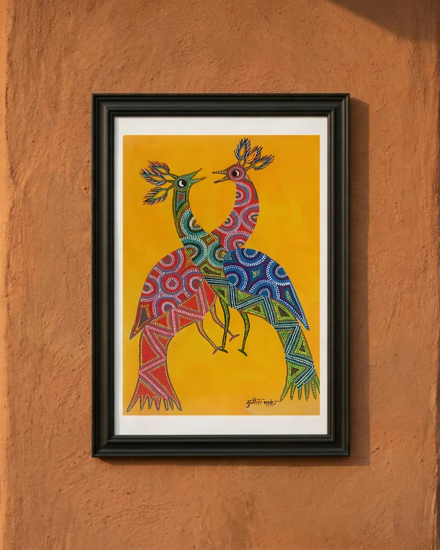 Framed artwork of two colorful peacocks on a yellow background, displayed on a textured brown wall.