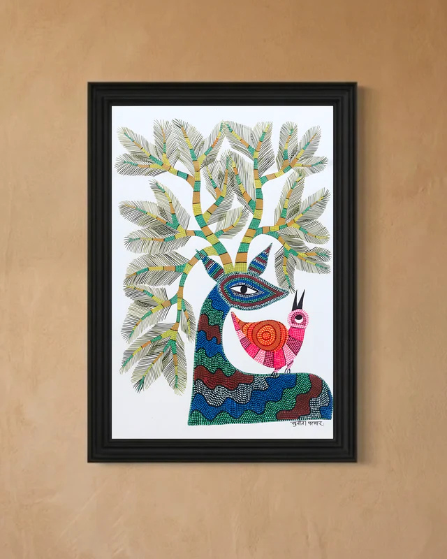 Framed artwork of a colorful tree with a face and bird on a beige wall